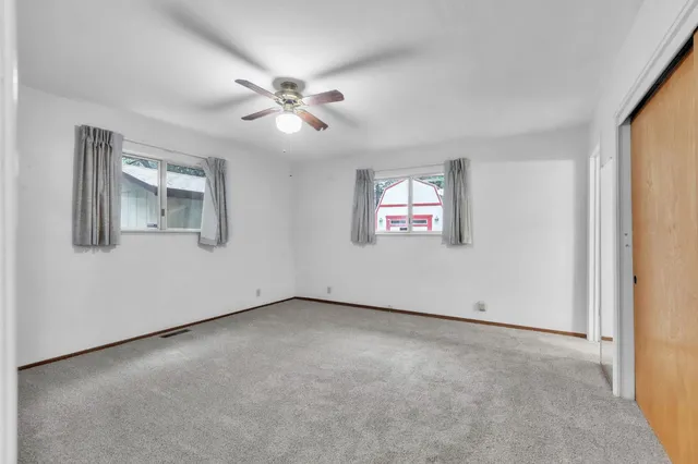a view of an empty room with a ceiling fan