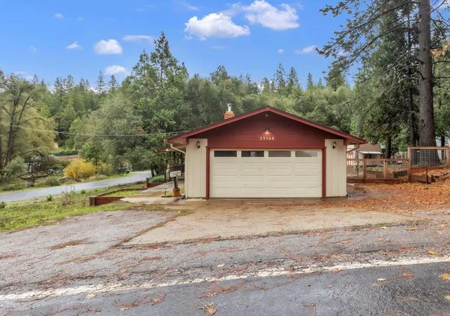 a view of a house with backyard and trees