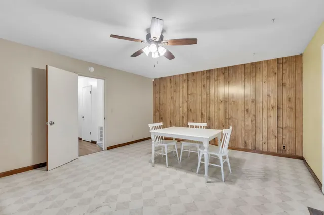 a view of kitchen with cabinets and window