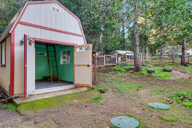 a backyard of a house with barbeque oven table and chairs