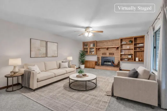 an empty room with furniture and chandelier fan