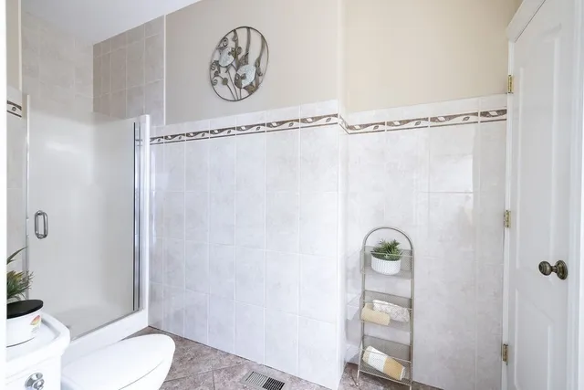 a bathroom with a shower a toilet and a shower