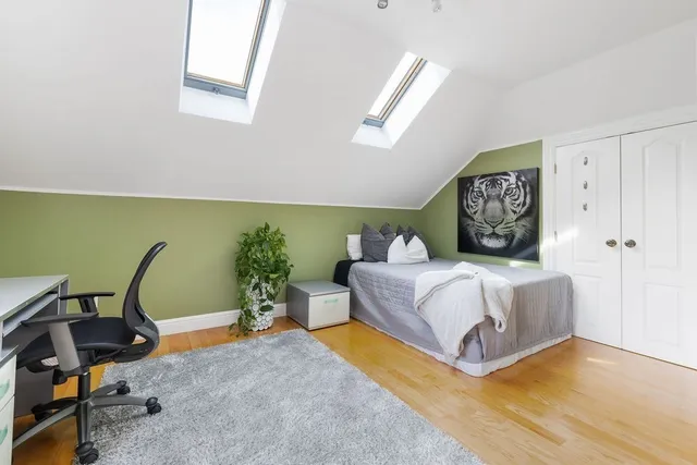 a bedroom with a bed window and table