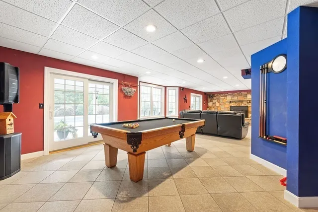 a room with pool table and windows