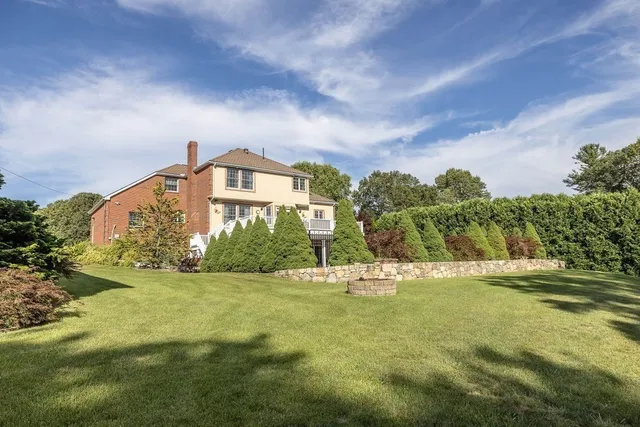a view of a big house with a big yard and plants