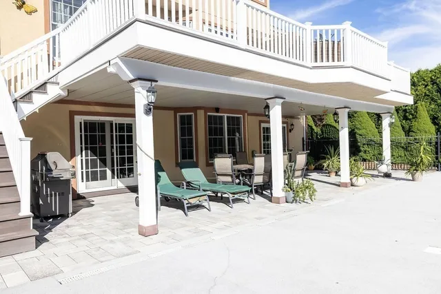a building outdoor space with couple of furniture and outdoor seating