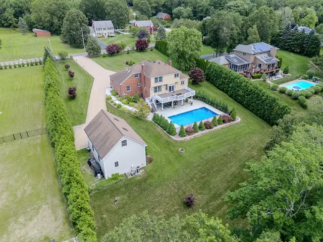 an aerial view of a house with swimming pool and outdoor space