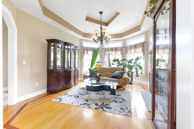 a living room with furniture a chandelier and a dining table