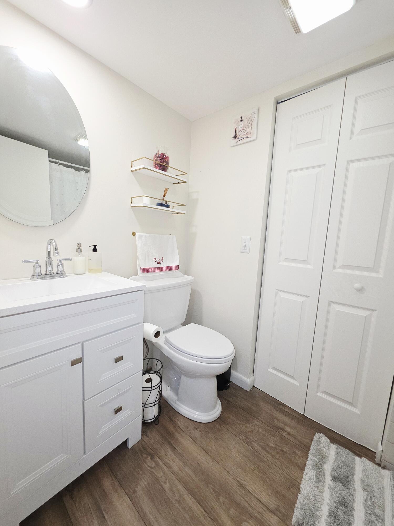 218 Woodland Road Palm Springs, FL 33461 - Photo 19 of 45 a bathroom with a toilet a sink and a mirror