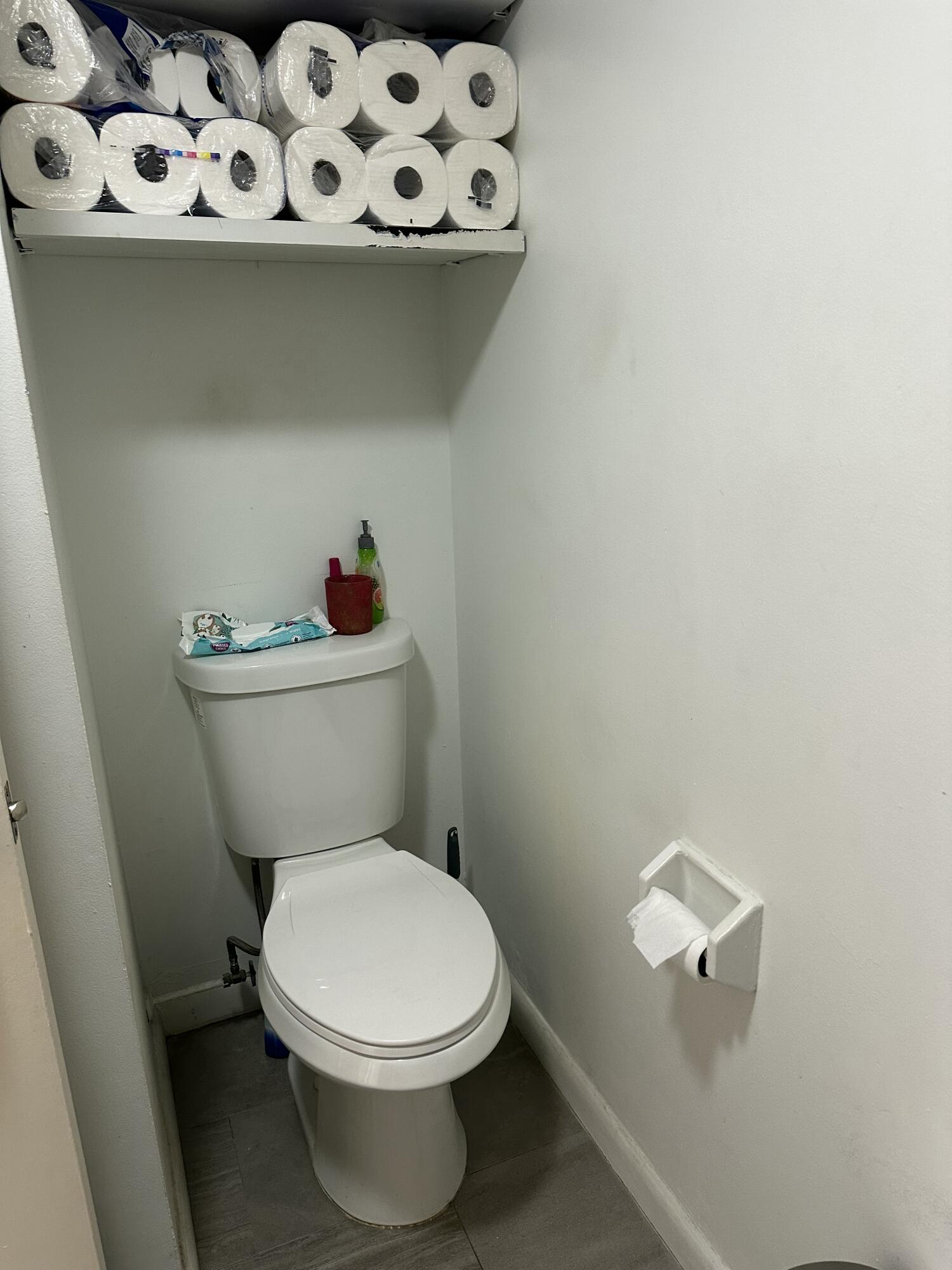 218 Woodland Road Palm Springs, FL 33461 - Photo 22 of 45 a white toilet sitting next to a sink and a window