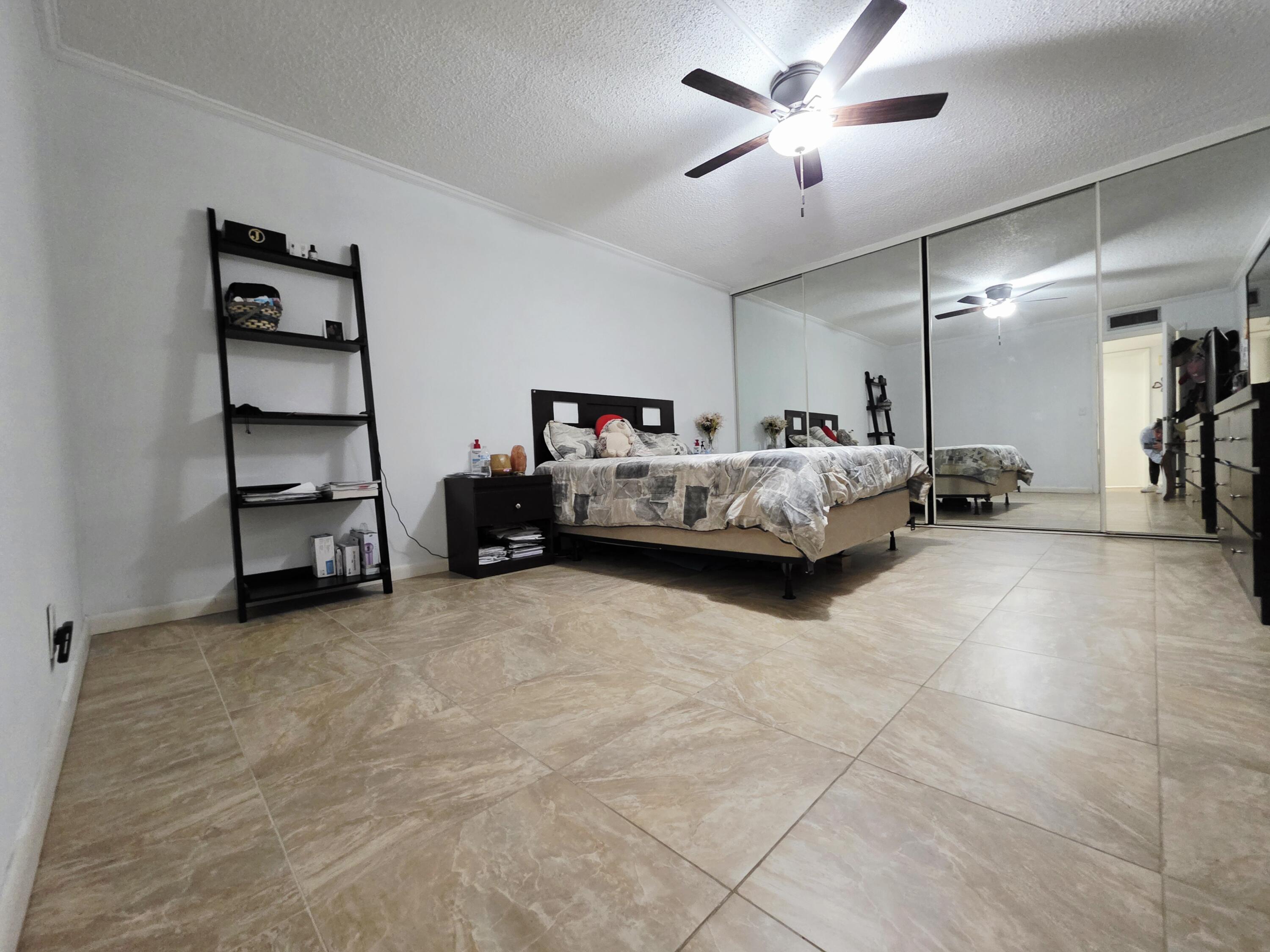 218 Woodland Road Palm Springs, FL 33461 - Photo 29 of 45 a living room with furniture and gym equipment