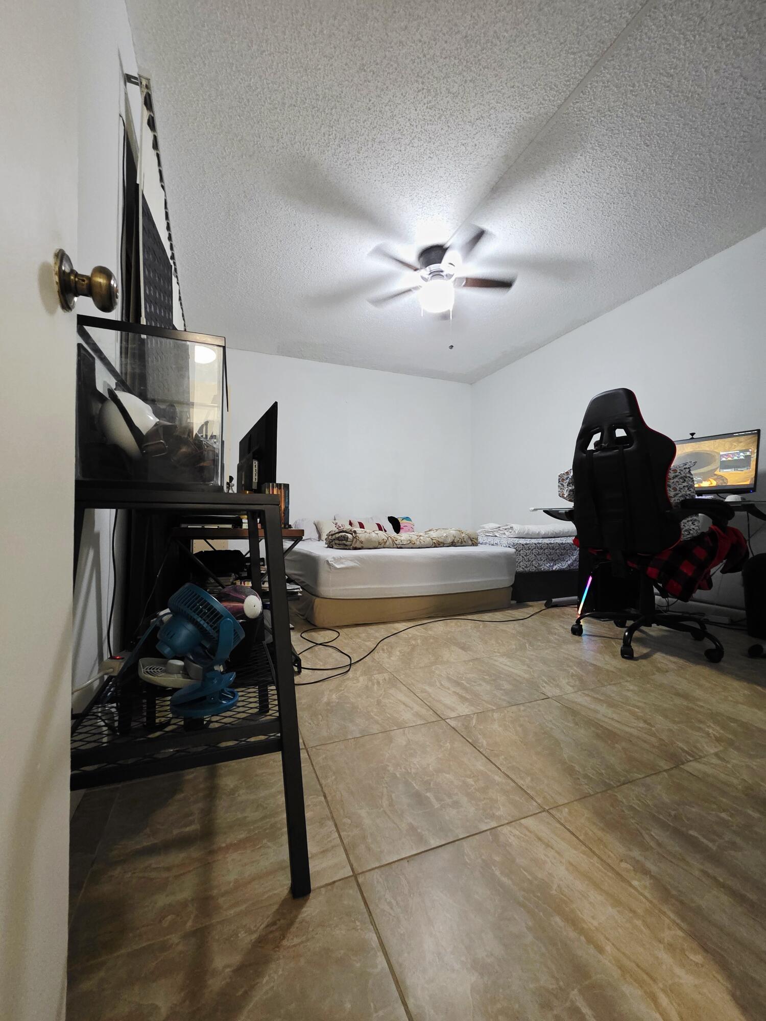 218 Woodland Road Palm Springs, FL 33461 - Photo 32 of 45 a room with gym equipment and a view of living room