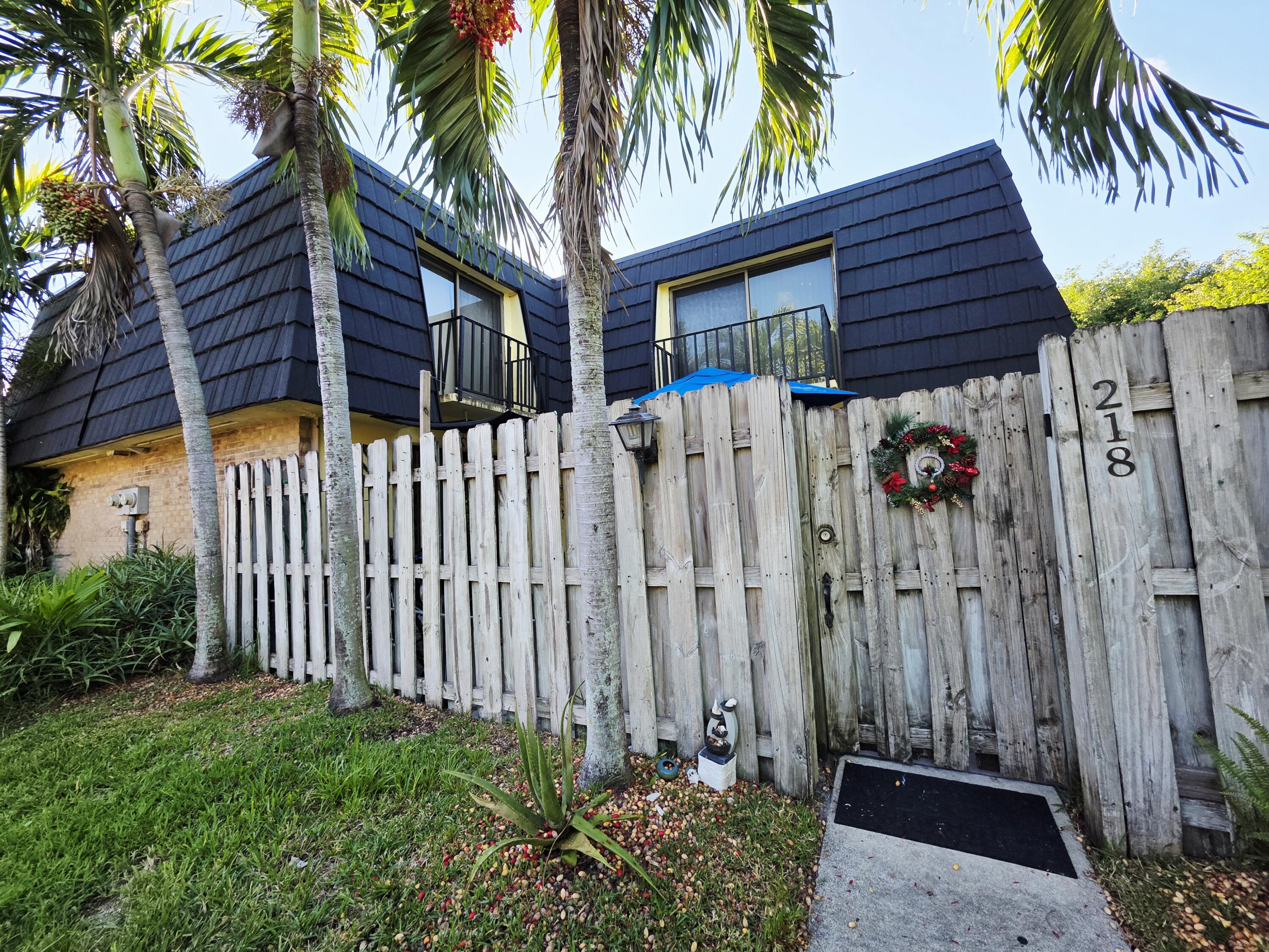 218 Woodland Road Palm Springs, FL 33461 - Photo 42 of 45 a view of a house with a small yard and plants