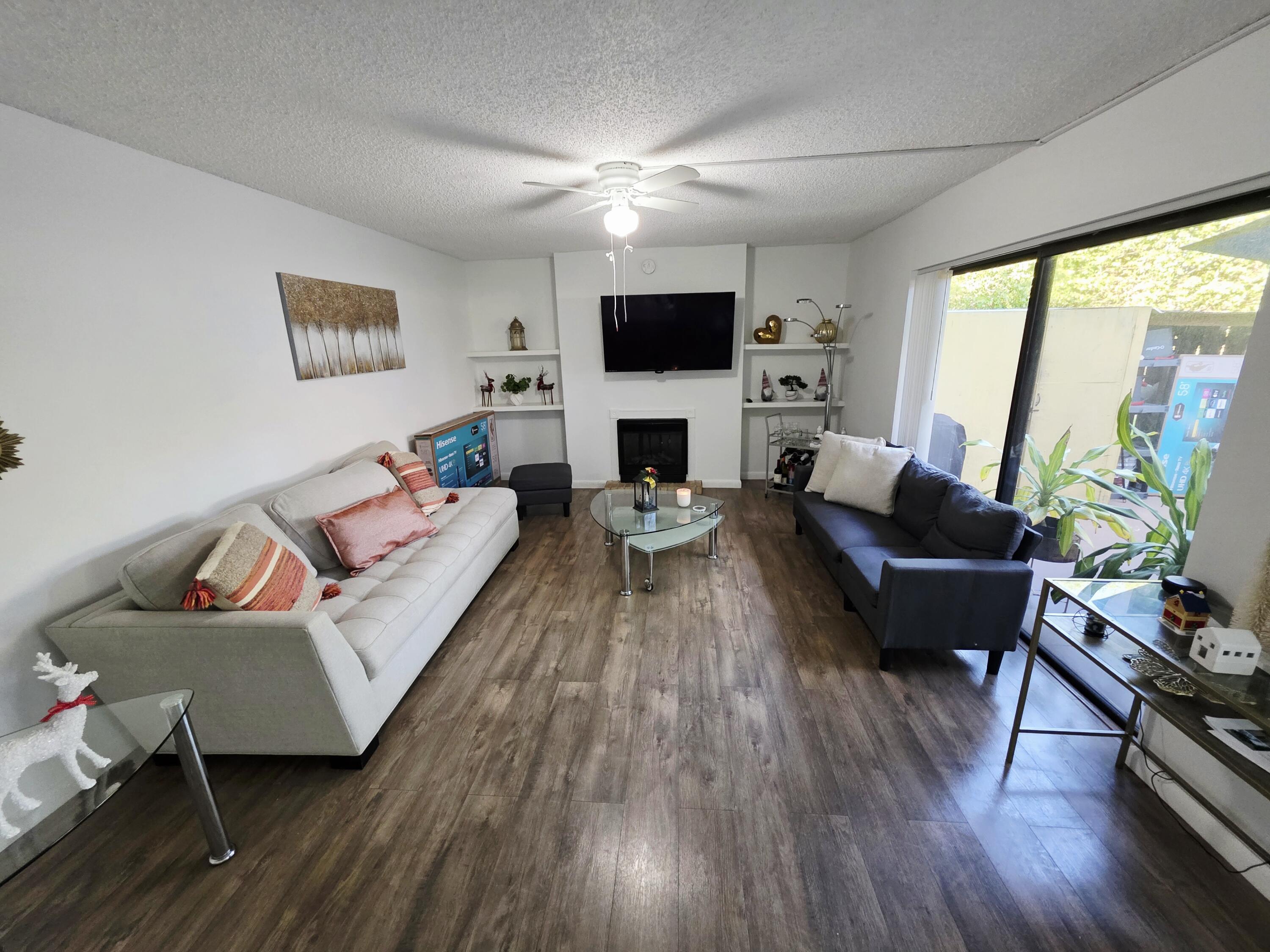 218 Woodland Road Palm Springs, FL 33461 - Photo 5 of 45 a living room with fireplace furniture and a flat screen tv