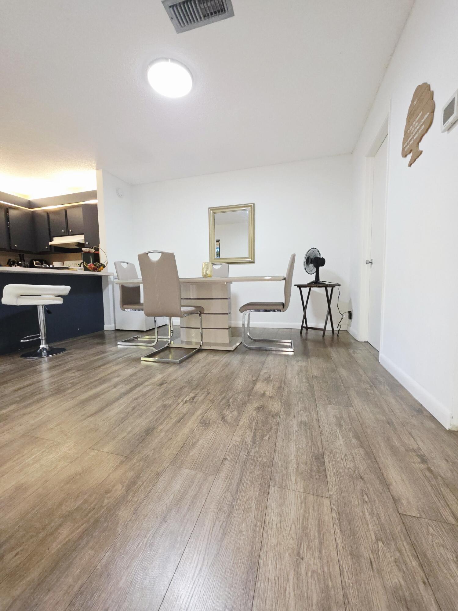 218 Woodland Road Palm Springs, FL 33461 - Photo 7 of 45 a living room with furniture and a wooden floor