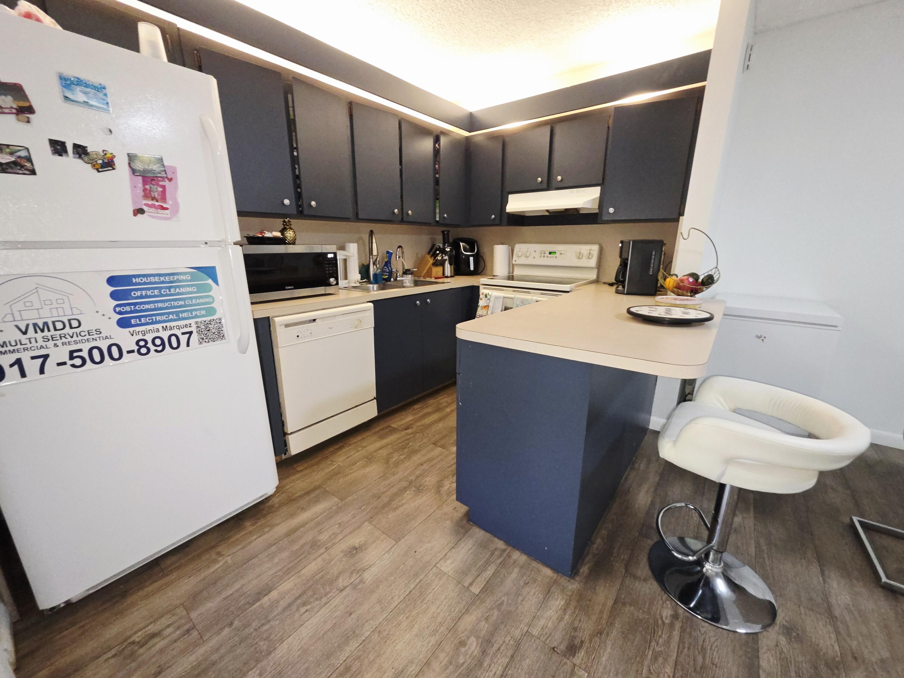 218 Woodland Road Palm Springs, FL 33461 - Photo 9 of 45 a kitchen with a sink cabinets and wooden floor