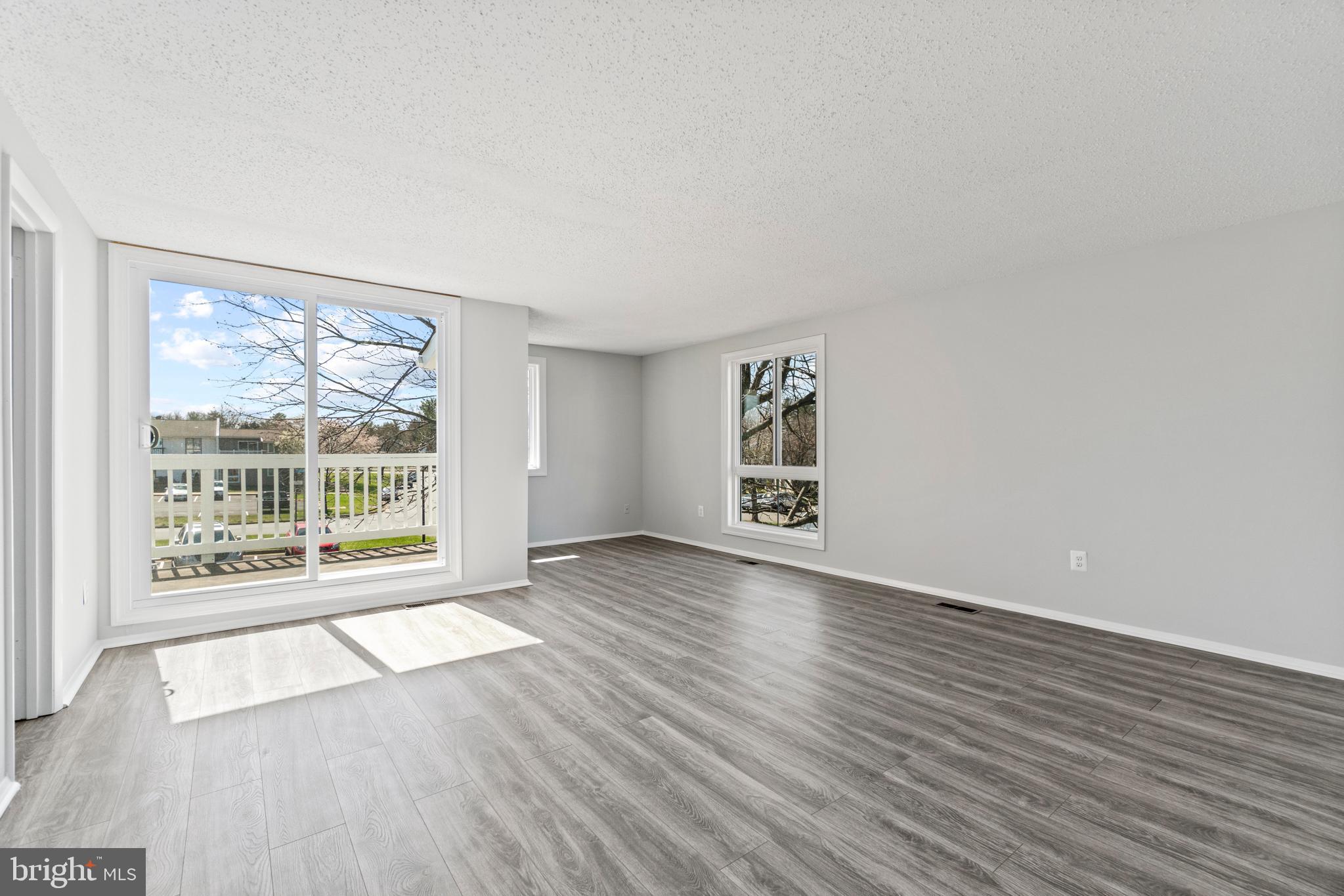2 Regis Circle Sterling, VA 20164 - Photo 15 of 20 a view of an empty room with wooden floor and a window