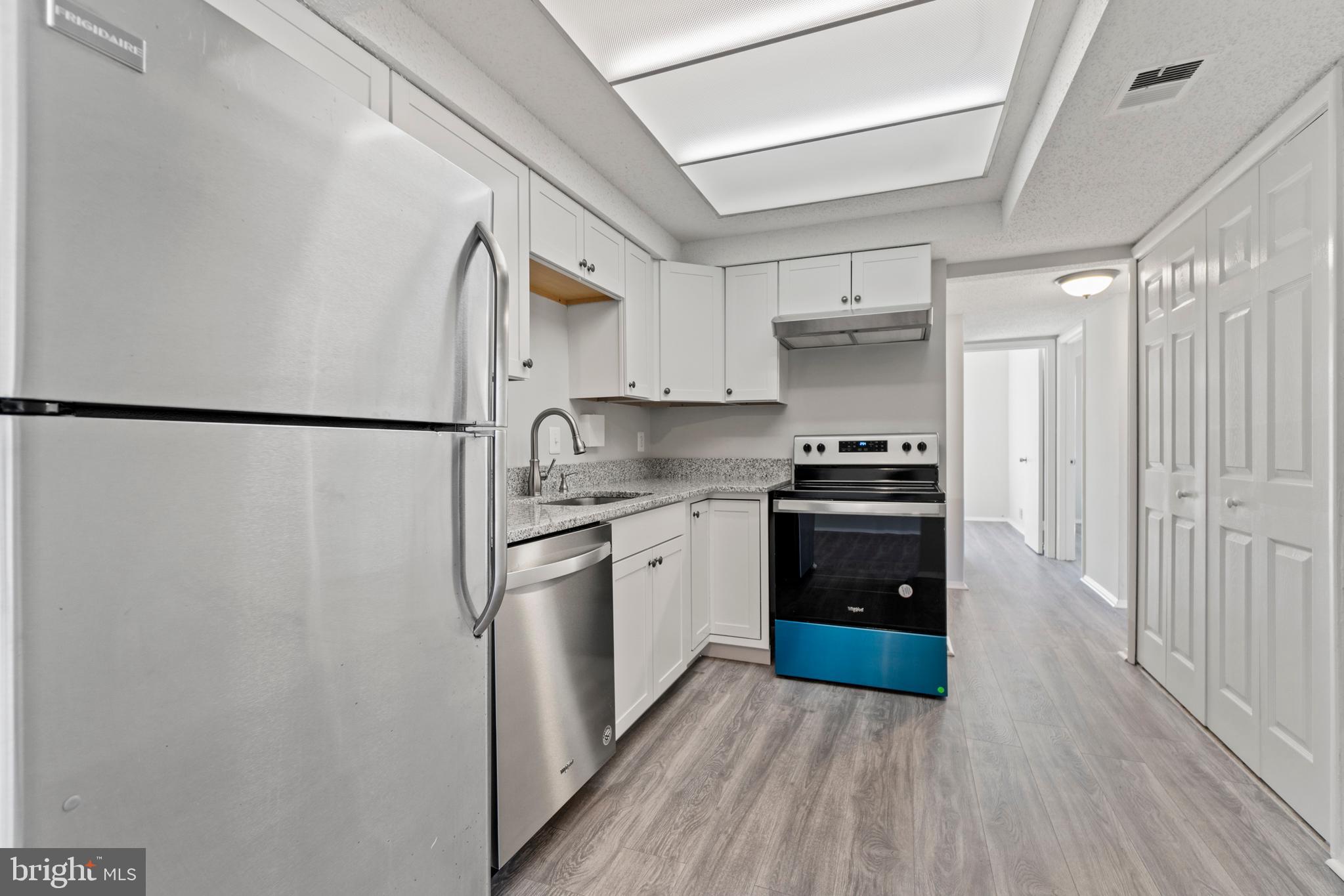 2 Regis Circle Sterling, VA 20164 - Photo 5 of 20 a kitchen with stainless steel appliances a refrigerator stove and white cabinets
