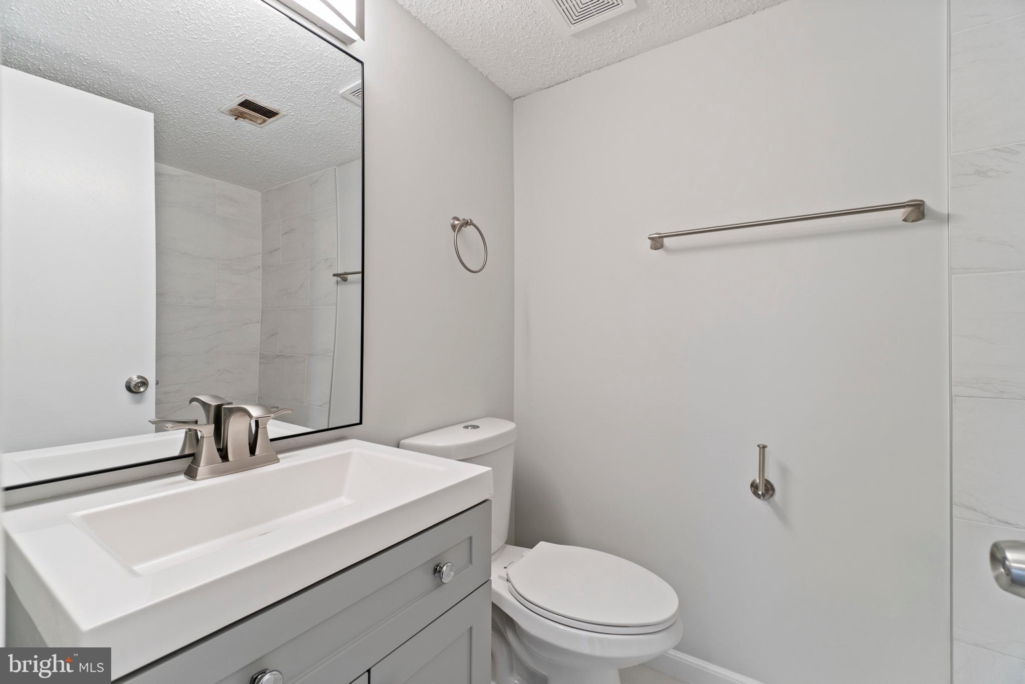 2 Regis Circle Sterling, VA 20164 - Photo 10 of 20 a bathroom with a sink a toilet and shower
