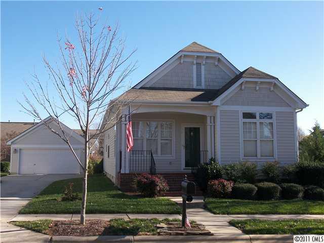 8307 Townley Road Huntersville, NC 28078 - Photo 1 of 16 a front view of a house with a garden
