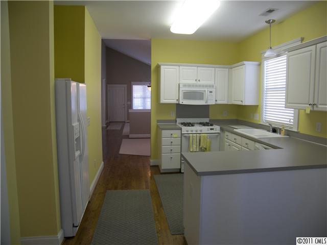 8307 Townley Road Huntersville, NC 28078 - Photo 7 of 16 a kitchen with kitchen island granite countertop a sink stove and refrigerator