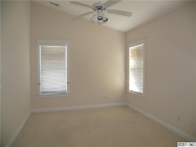 8307 Townley Road Huntersville, NC 28078 - Photo 8 of 16 an empty room with a window and a ceiling fan