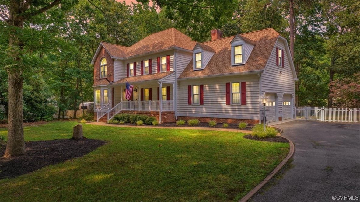a front view of a house with garden and swimming pool