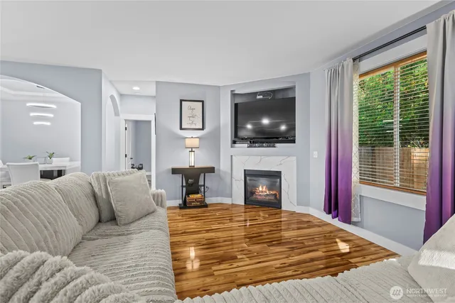 a living room with furniture a fireplace and a flat screen tv