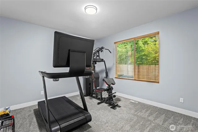 a room with gym equipment and windows