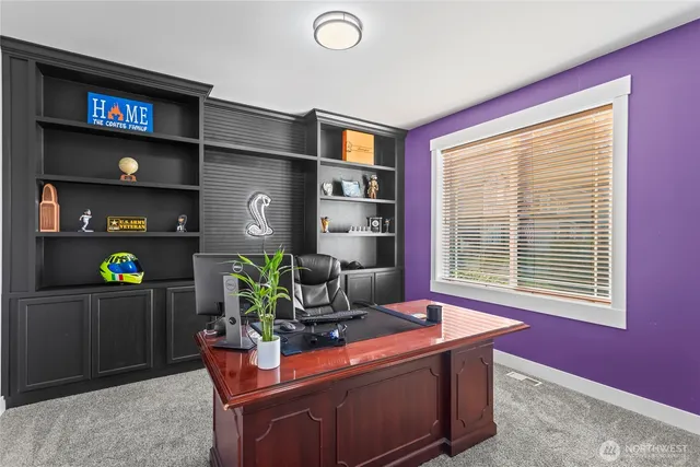 a living room with fireplace furniture and a window