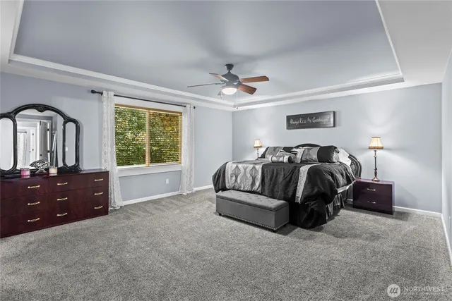 a spacious bedroom with a bed and a dresser