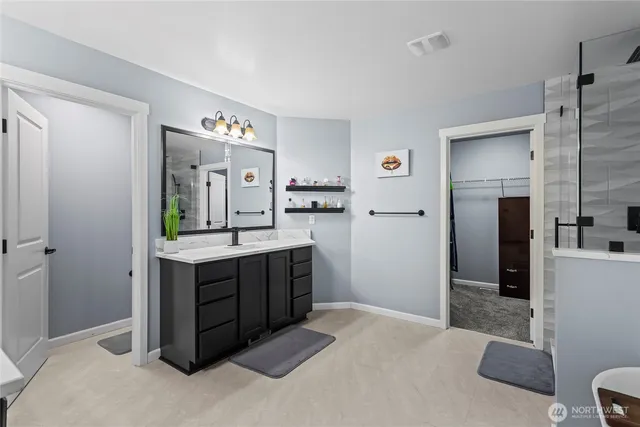 a spacious bathroom with a granite countertop sink mirror and shower