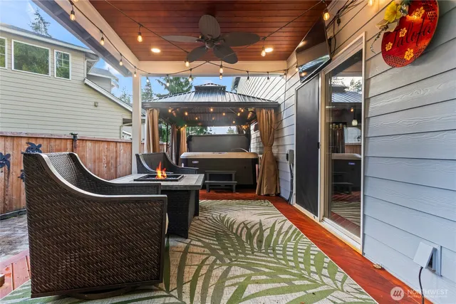 a view of roof deck with chair and tables