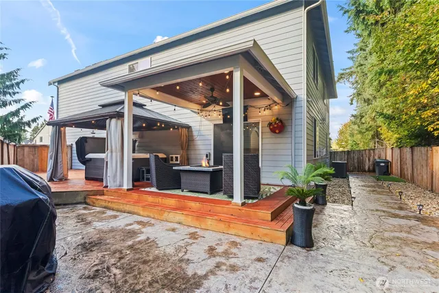 a view of a house with backyard and sitting area