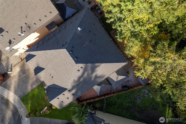 an aerial view of a house with a yard