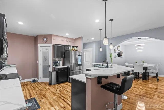 a large kitchen with a table and chairs