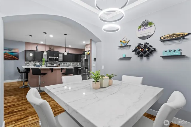 a kitchen with a dining table and chairs