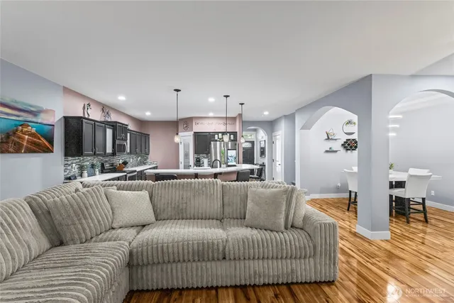a living room with furniture and kitchen view