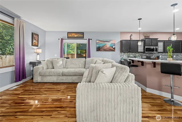 a living room with furniture a flat screen tv and a table