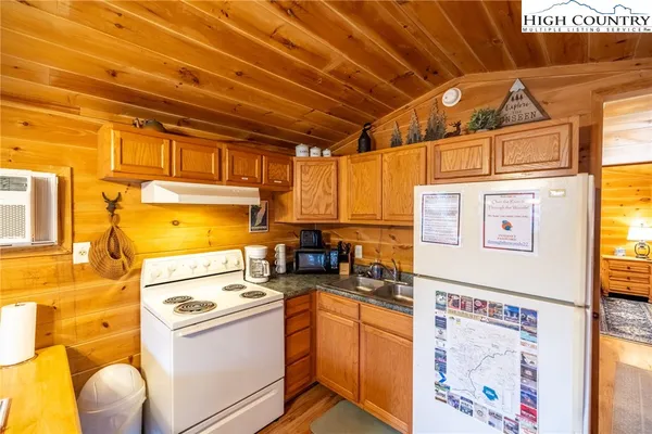 a view of a kitchen with a sink and a refrigerator