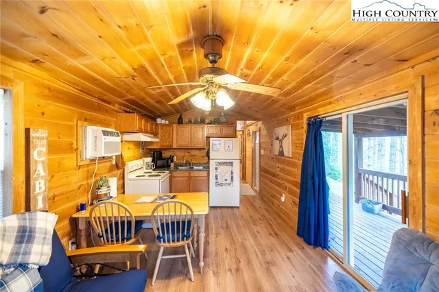 a dining room with furniture and wooden floor