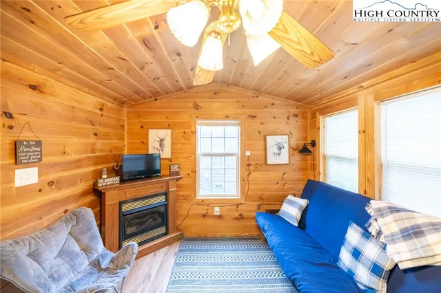 a living room with furniture a fireplace and a table