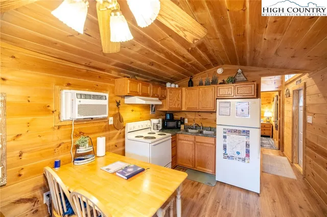a kitchen with stainless steel appliances granite countertop a sink and wooden cabinets