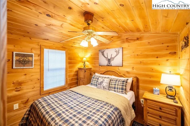 a bedroom with a bed and a night stand