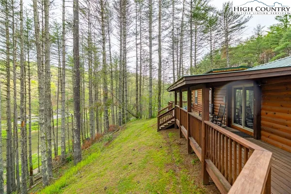 a view of a house with backyard and deck
