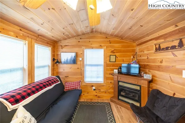 a utility room with stainless steel appliances wooden floor and window