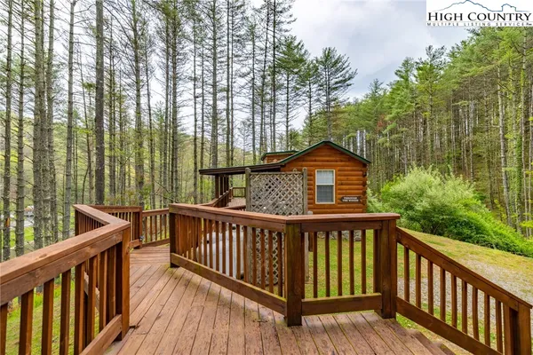 a view of a wooden fence and trees