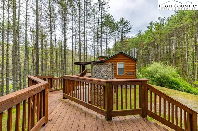 a view of a wooden fence and trees