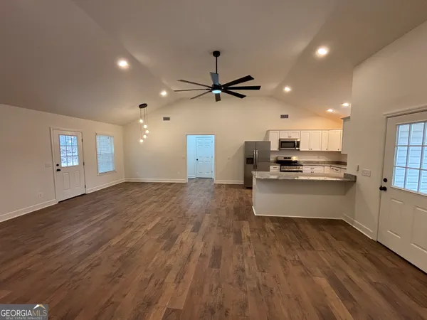 a view of kitchen with sink and wooden floor