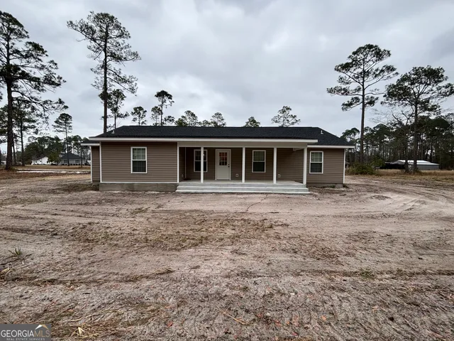 a view of a house with a backyard